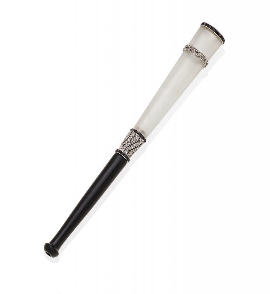 AN ART DECO DIAMOND, ONYX, ROCK CRYSTAL AND BAKELITE CIGARETTE HOLDER