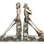 A PAIR OF EARLY 20TH CENTURY SILVERED BRONZE AND MARBLE BOOKENDS