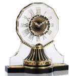 An Art Deco Rock Crystal, Enamel, Onyx and Diamond Demi-Mystery Clock