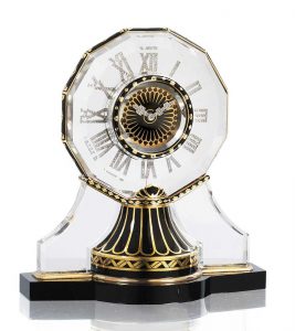 An Art Deco Rock Crystal, Enamel, Onyx and Diamond Demi-Mystery Clock