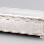 AN ENGINE-TURNED SILVER CIGARETTE BOX BIRMINGHAM, 1935