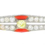 JANESICH - an Art Deco platinum diamond, coloured diamond and coral pin