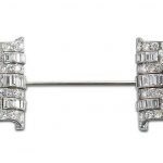 AN ART DECO DIAMOND AND GEM-SET JABOT PIN