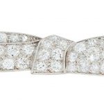 AN ART DECO DIAMOND BOW BROOCH designed as a ribbon