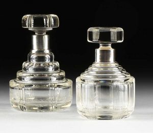 A GROUP OF TWO FRENCH ART DECO STERLING SILVER MOUNTED CUT CRYSTAL DECANTERS